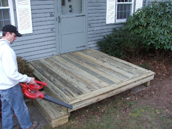 tim blowing off anna's new front deck.jpg